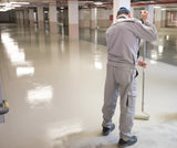 Man painting concrete floor